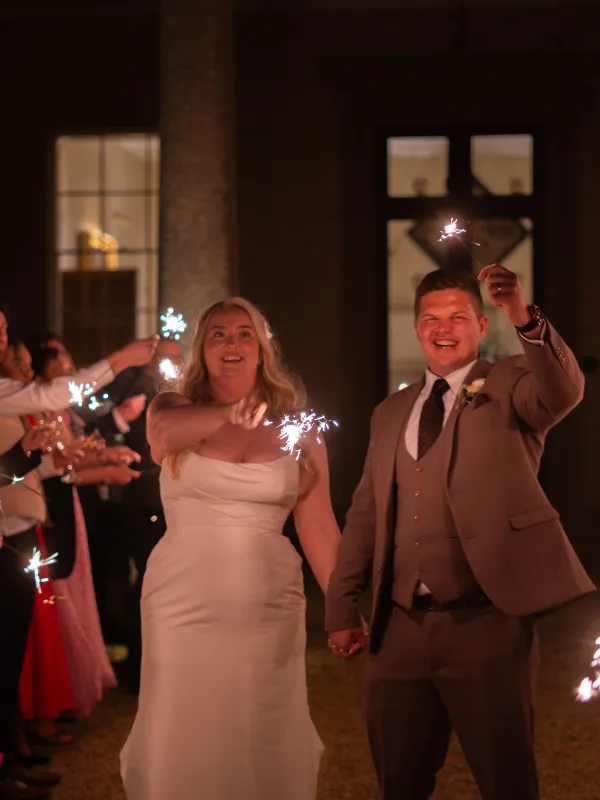 Newlyweds walk through a sparkler tunnel at Stubton Hall